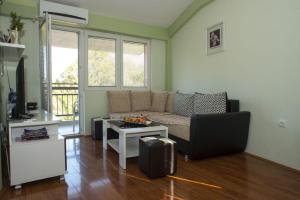 a living room with a couch and a table at Apartments Villa Zora in Star Dojran