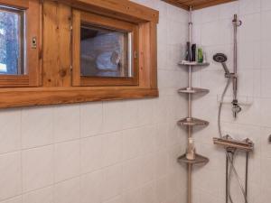 a bathroom with a shower and a window at Holiday Home Salmikangas h2 by Interhome in Ruka