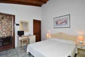 Postel nebo postele na pokoji v ubytování Li Suari Club Village