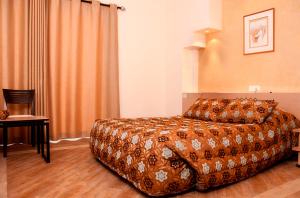 a hotel room with a bed and a chair at Marble Tower in Beirut