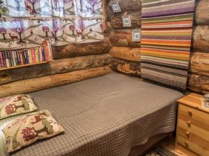 a small bedroom with a bed in a log cabin at Holiday Home Salmikangas h2 by Interhome in Ruka
