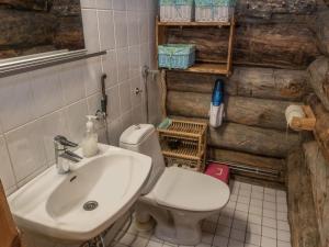 a bathroom with a sink and a toilet at Holiday Home Salmikangas h2 by Interhome in Ruka