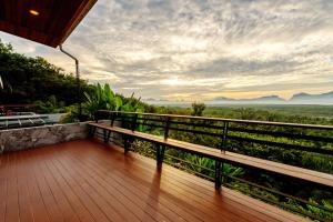 a balcony of a house with a view of the mountains at Ao Luek Panoramic Pool-SHA Plus in Ao Luk