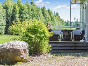 a porch of a house with a rock at Holiday Home Kaisla by Interhome in Torvoila