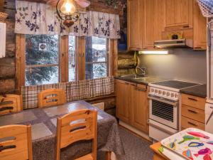 a kitchen with a table and a stove top oven at Holiday Home Salmikangas h2 by Interhome in Ruka