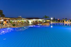 a large swimming pool at night at Makronisos Village in Ayia Napa