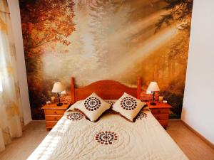 a bedroom with a bed with a painting on the wall at Holiday Home Vicky by Interhome in Riumar