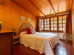 a bedroom with a bed in a room with wooden walls at Holiday Home Nellyana by Interhome in Riumar