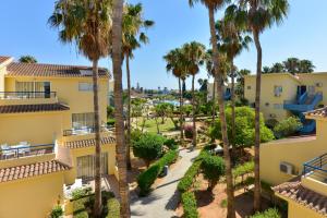 an aerial view of the courtyard of a building with palm trees at Makronisos Village in Ayia Napa