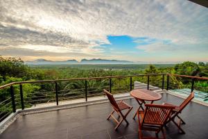 a balcony with a table and chairs and a view at Ao Luek Panoramic Pool-SHA Plus in Ao Luk