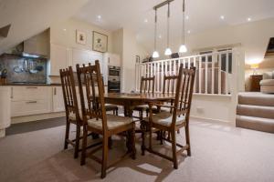 a dining room with a wooden table and chairs at Bank Street Gallery in Kirriemuir