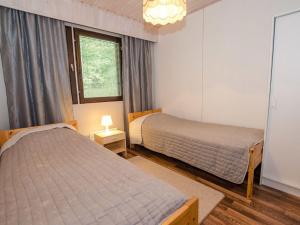 1 dormitorio con 2 camas y ventana en Holiday Home Lomaranta by Interhome, en Ruvaslahti