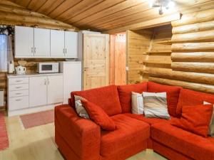 a living room with a red couch in a kitchen at Holiday Home Honkakeko by Interhome in Sirkka