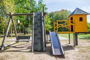 a playground with a slide and a play structure at Kempings Usmas Meķi in Renda