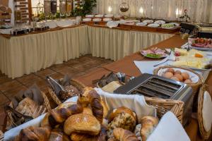 a table with bread and eggs and other food on it at Hotel Restaurant Meteora in Tübingen