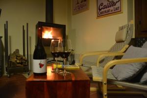 a room with a bottle of wine and two glasses at Feudi Spada casa vacanze in Orvieto +24 photos