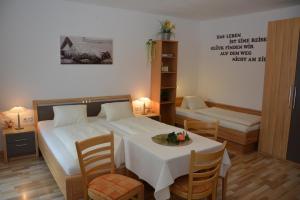 a bedroom with a bed and a table and chairs at Haus Ingrid in Sankt Georgen ob Murau
