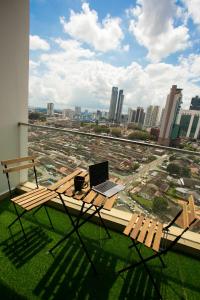 a laptop computer sitting on a table on a balcony at Ksl City Mall D'esplanade By The one in Johor Bahru