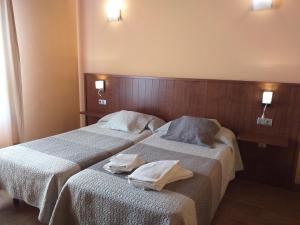 dwa łóżka w pokoju hotelowym z ręcznikami na nich w obiekcie OTXOENEA w mieście Irún