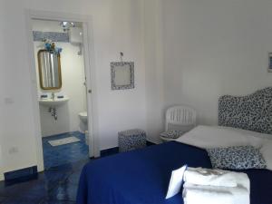 a bedroom with a blue bed and a sink at Casa Blu Cobalto in Maiori