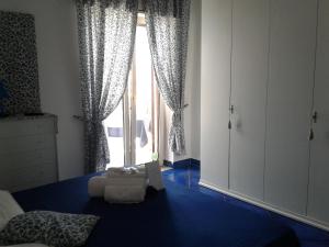 a bedroom with a bed and a large window at Casa Blu Cobalto in Maiori