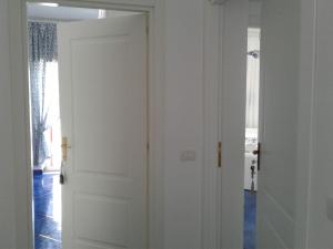 a white door in a room with a window at Casa Blu Cobalto in Maiori