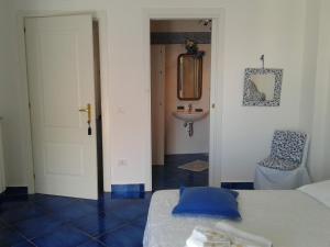 a room with a bed and a sink and a door at Casa Blu Cobalto in Maiori