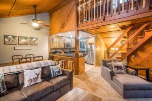 a living room with a couch and a table and a kitchen at Hidden Haven Condominium in Shaver Lake