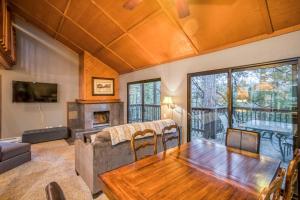 a living room with a table and a couch and a fireplace at Hidden Haven Condominium in Shaver Lake