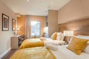 Ένα ή περισσότερα κρεβάτια σε δωμάτιο στο Dwell City Living