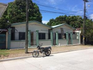 a motorcycle parked in front of a house at Elizabeth Enchantments in La Ceiba