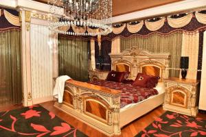 a bedroom with a large bed with a chandelier at Sheikh Apartment in Baku in Baku +45 photos