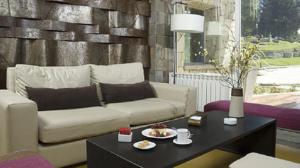 a living room with a couch and a coffee table at Hosteria ACA al Sur in Villa La Angostura