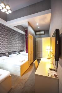 Ένα ή περισσότερα κρεβάτια σε δωμάτιο στο Rustaveli Hotel