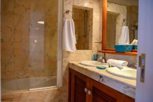 a bathroom with a tub and a sink and a shower at Lantia Rooftop House in Arrecife +49 photos
