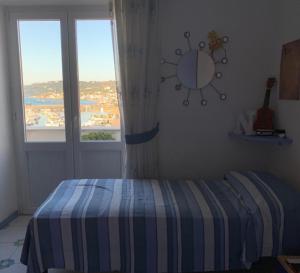 A bed or beds in a room at La Stanza sul Porto