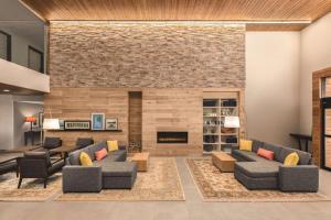 a living room with couches and a fireplace at Country Inn & Suites by Radisson, Lubbock Southwest, TX in Lubbock
