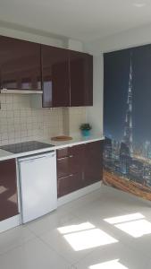 a kitchen with a view of a city skyline at Centre Apartamenty Warszawa in Warsaw