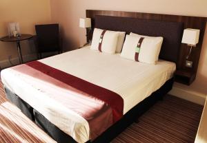 a hotel room with a bed and two nightstands at Holiday Inn Rotherham-Sheffield M1,Jct.33, an IHG Hotel in Rotherham