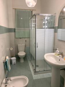 a bathroom with a shower and a toilet and a sink at Domus Grace in Catania