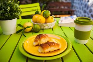 two pastries on an orange plate on a green table at Green Lime Studio in Bansko +7 photos