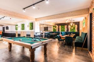 a pool table in a room with a bar at Aparthotel Diamond SPA Family in Białka Tatrzanska