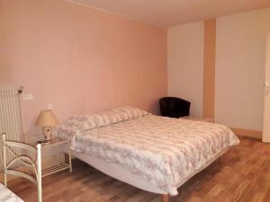a bedroom with a bed and a desk and a chair at Hotel Pension Le Beauregard in Divonne-les-Bains