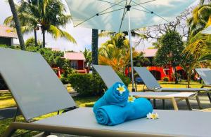 a blue figurine sitting on a table with an umbrella at Flowers of Paradise in Mont Choisy