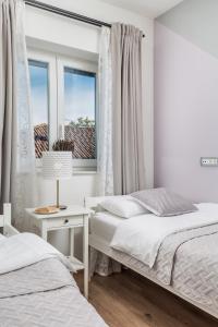 Postel nebo postele na pokoji v ubytování New Cosy Apartment Ivan