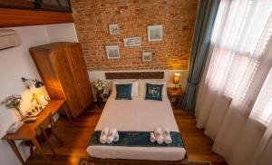 Postel nebo postele na pokoji v ubytování Sweet Cili Boutique Hotel