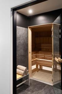 a walk in shower with a bench in a room at YOOMA Urban Lodge in Paris