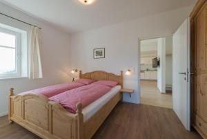 A bed or beds in a room at Mairhof