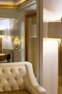 a living room with a white couch and a mirror at Hotel Galaxias in Rhodes Town