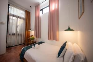 Postel nebo postele na pokoji v ubytování Sweet Cili Boutique Hotel